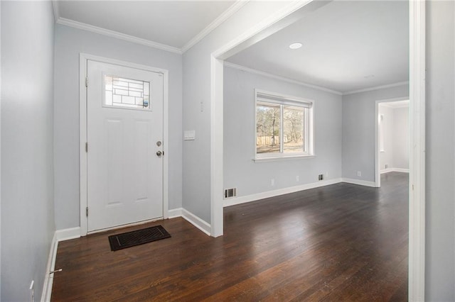 foyer entrance with crown molding, dark wood finished floors, visible vents, and baseboards