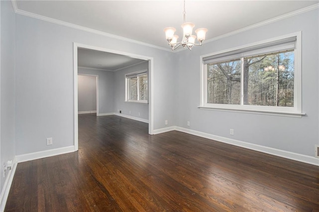 unfurnished room featuring a chandelier, crown molding, dark wood-style flooring, and baseboards