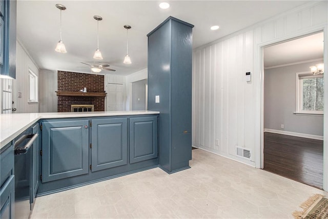 kitchen with a ceiling fan, visible vents, light countertops, blue cabinetry, and decorative light fixtures