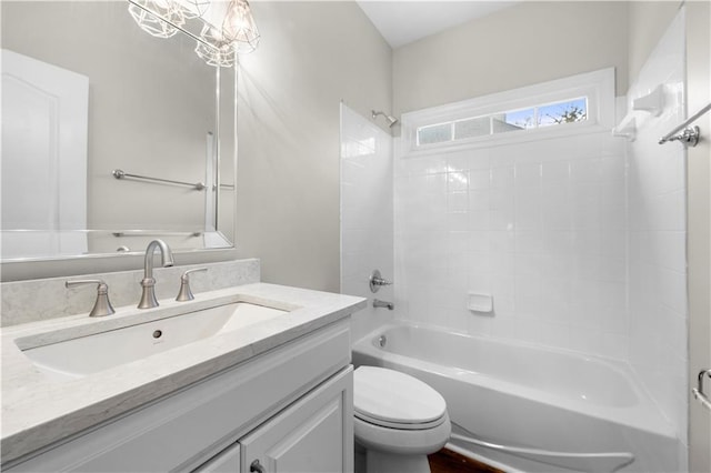 bathroom with toilet, washtub / shower combination, and vanity