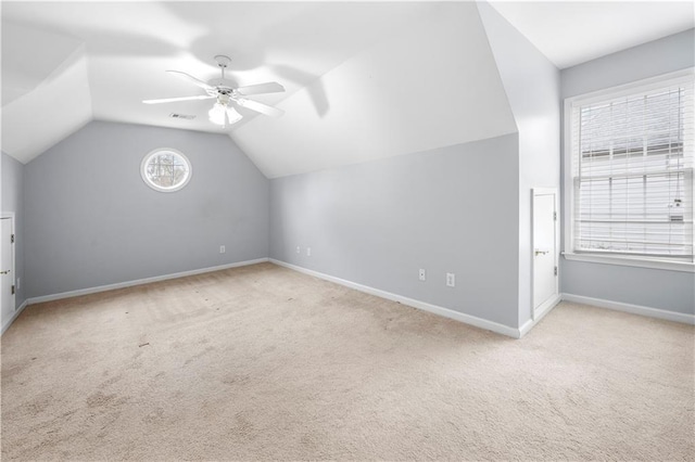 bonus room featuring carpet, lofted ceiling, visible vents, ceiling fan, and baseboards