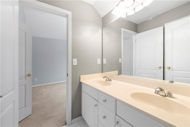 bathroom featuring a sink, baseboards, and double vanity