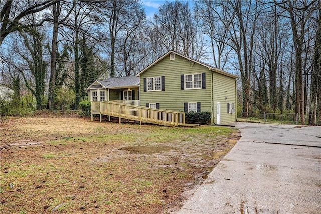 view of front of property featuring a deck and fence