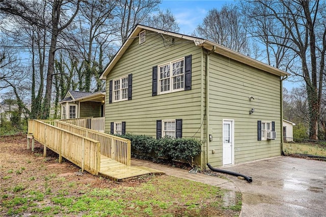 back of house featuring a wooden deck, a patio, cooling unit, and fence