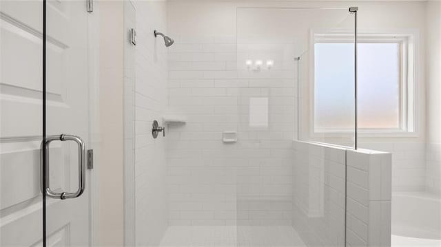 bathroom featuring separate shower and tub