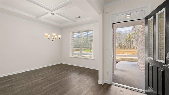 interior space featuring dark hardwood / wood-style floors, coffered ceiling, an inviting chandelier, and crown molding