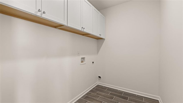 clothes washing area with cabinets, hookup for an electric dryer, and hookup for a washing machine