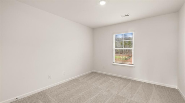 unfurnished room with light carpet