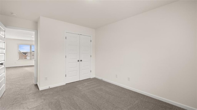 unfurnished bedroom with carpet floors and a closet