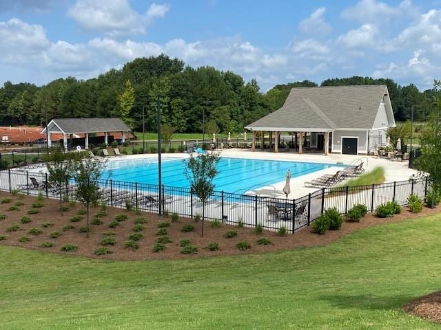 view of swimming pool featuring a yard and a patio area