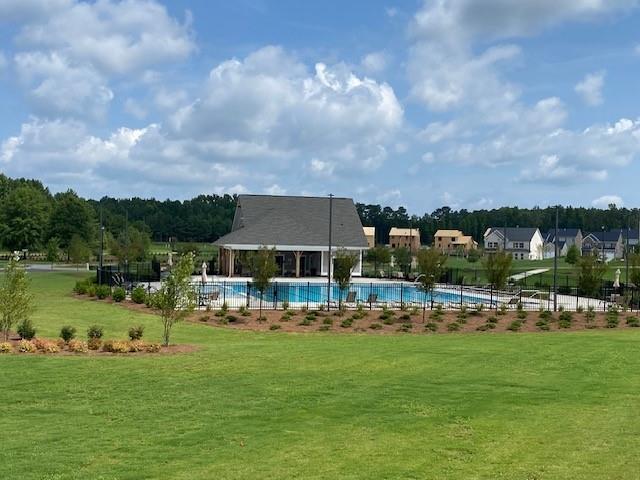 view of swimming pool with a lawn