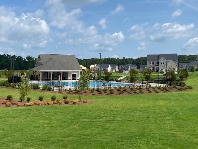 view of property's community featuring a pool and a yard