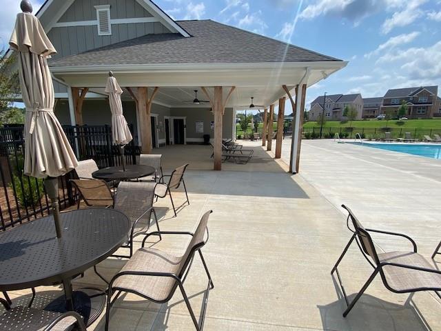 view of patio / terrace featuring a community pool and ceiling fan