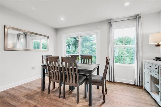 dining room featuring recessed lighting, baseboards, and light wood-type flooring