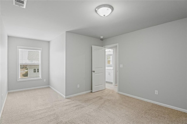 unfurnished bedroom with carpet, visible vents, and baseboards