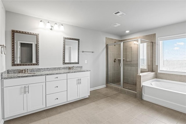 bathroom featuring a garden tub, double vanity, visible vents, a sink, and a shower stall