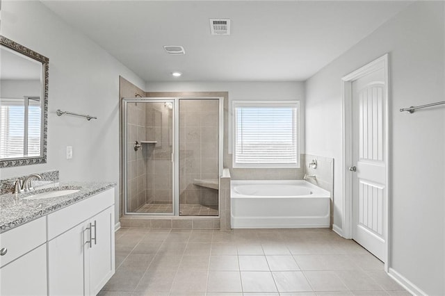 bathroom featuring a stall shower, visible vents, a garden tub, tile patterned flooring, and vanity