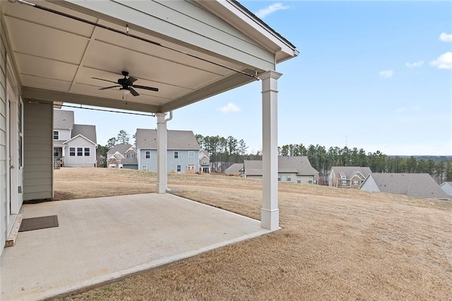 view of patio / terrace featuring ceiling fan and a residential view