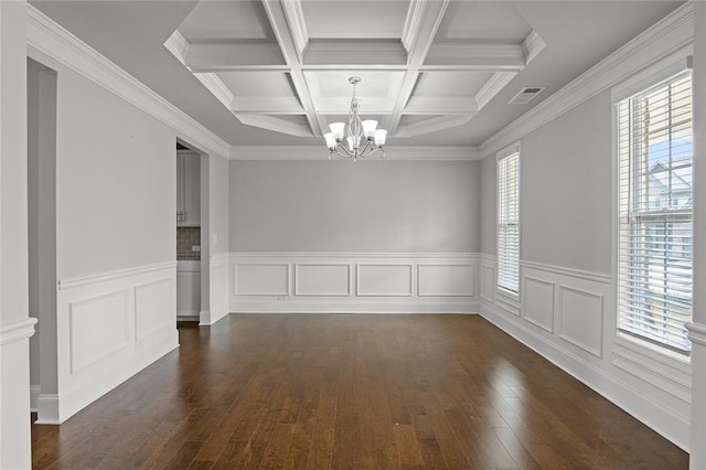 unfurnished room with visible vents, coffered ceiling, dark wood-type flooring, beamed ceiling, and a notable chandelier