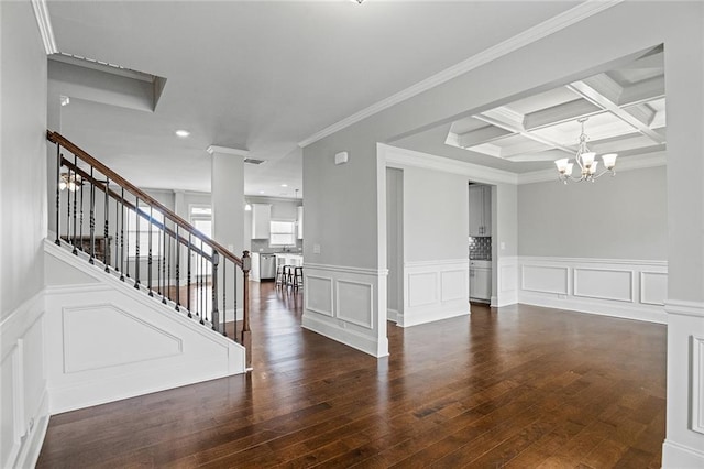 empty room featuring beam ceiling, decorative columns, stairway, coffered ceiling, and hardwood / wood-style flooring