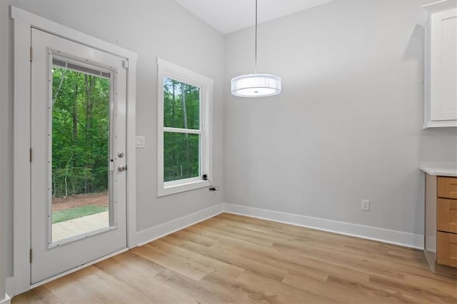 3902 Bouldercrest Rd SE, Ellenwood, GA 30294 - unfurnished dining area with light wood-style flooring and baseboards