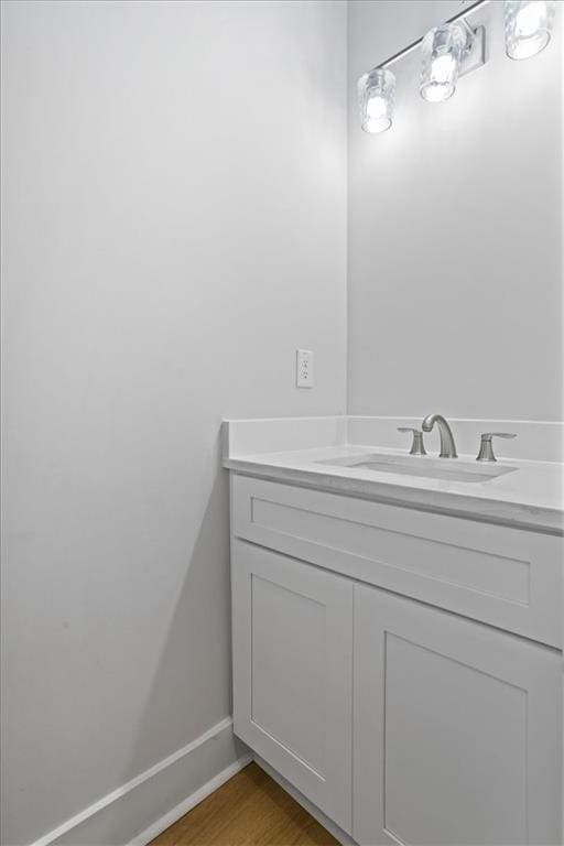 3902 Bouldercrest Rd SE, Ellenwood, GA 30294 - bathroom with wood finished floors, baseboards, and vanity