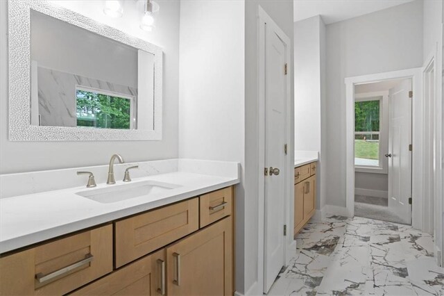 3902 Bouldercrest Rd SE, Ellenwood, GA 30294 - bathroom with vanity, baseboards, and marble finish floor