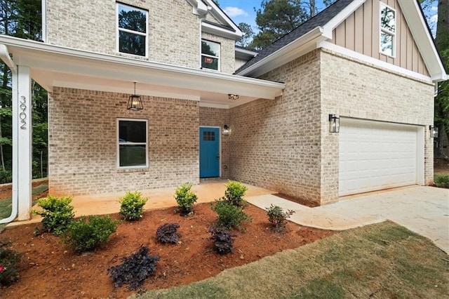 3902 Bouldercrest Rd SE, Ellenwood, GA 30294 - view of exterior entry featuring an attached garage, board and batten siding, and brick siding