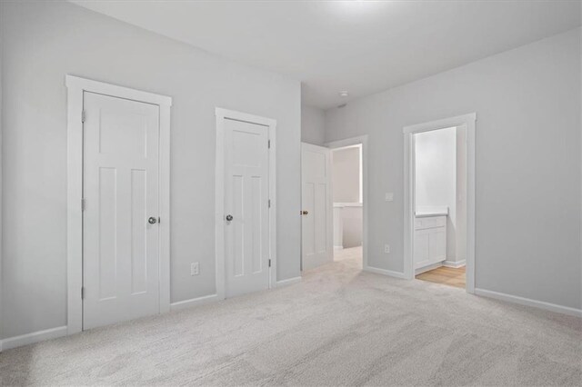 3902 Bouldercrest Rd SE, Ellenwood, GA 30294 - unfurnished bedroom with carpet flooring, ensuite bathroom, and baseboards