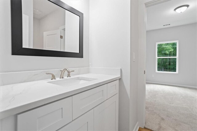 3902 Bouldercrest Rd SE, Ellenwood, GA 30294 - bathroom featuring visible vents, baseboards, and vanity