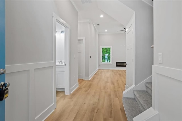 3902 Bouldercrest Rd SE, Ellenwood, GA 30294 - hall featuring light wood-style flooring, recessed lighting, baseboards, a sink, and crown molding
