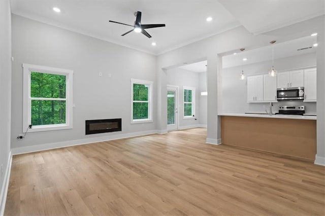 3902 Bouldercrest Rd SE, Ellenwood, GA 30294 - unfurnished living room featuring ceiling fan, baseboards, light wood-type flooring, and visible vents