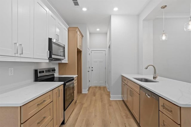 3902 Bouldercrest Rd SE, Ellenwood, GA 30294 - kitchen featuring pendant lighting, light wood finished floors, a sink, a peninsula, and appliances with stainless steel finishes