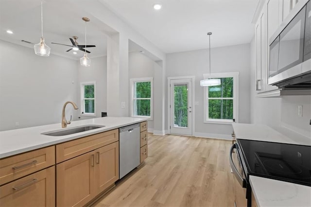 3902 Bouldercrest Rd SE, Ellenwood, GA 30294 - kitchen featuring decorative light fixtures, light countertops, appliances with stainless steel finishes, and a sink
