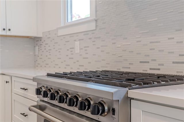 668 Liella Park SE, Atlanta, GA 30312 - room details with white cabinetry, tasteful backsplash, and high end stove