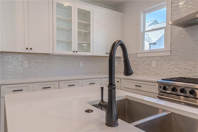 668 Liella Park SE, Atlanta, GA 30312 - kitchen with white cabinetry, backsplash, wall chimney range hood, and sink