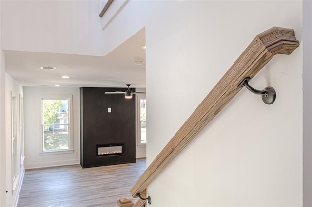668 Liella Park SE, Atlanta, GA 30312 - stairway featuring a large fireplace, hardwood / wood-style flooring, and ceiling fan