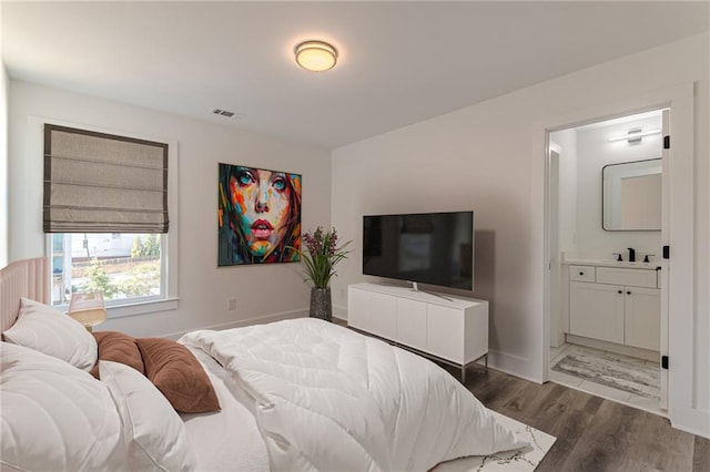668 Liella Park SE, Atlanta, GA 30312 - bedroom with sink, ensuite bath, and dark hardwood / wood-style flooring