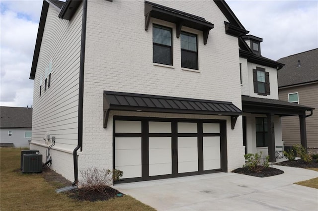 view of front facade with a garage and central AC