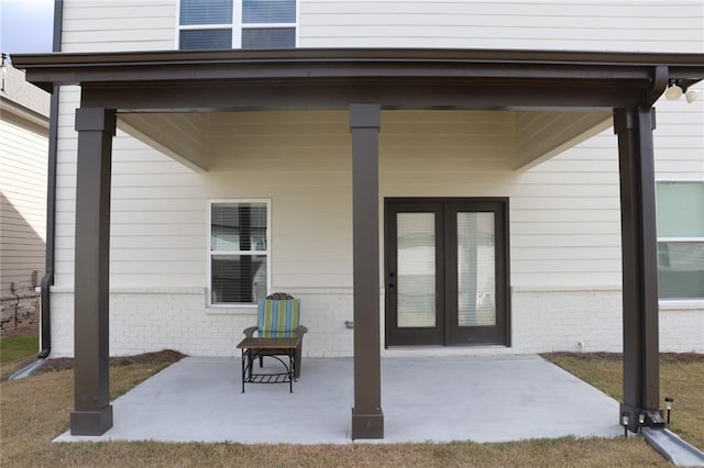 property entrance with a patio area and french doors