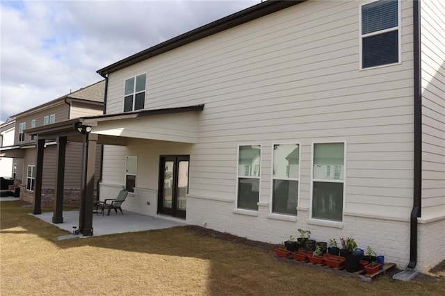 back of house featuring a yard and a patio