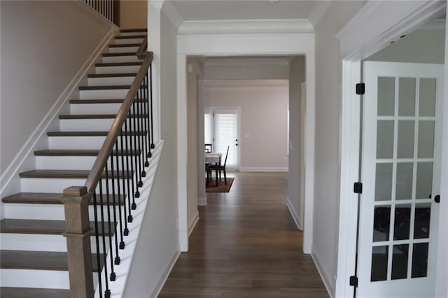 staircase with crown molding and wood-type flooring