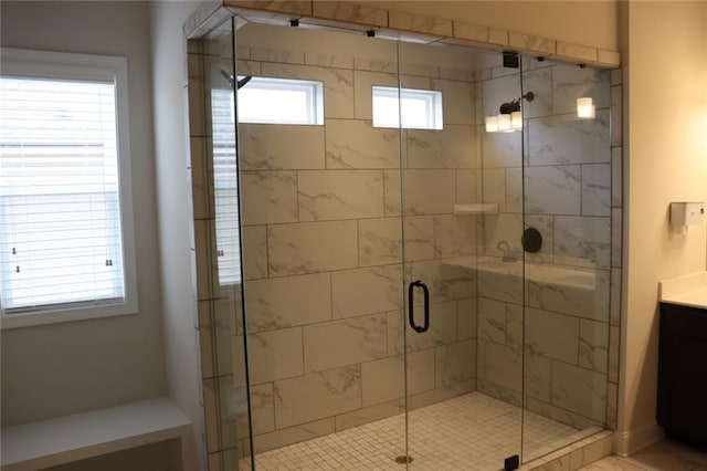 bathroom with an enclosed shower, a healthy amount of sunlight, and vanity