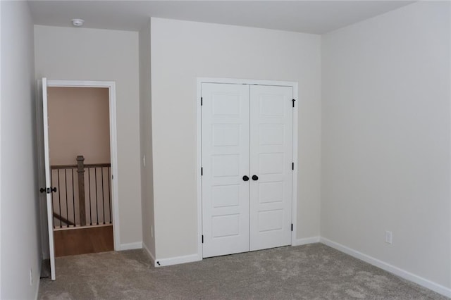 unfurnished bedroom featuring a closet and carpet floors