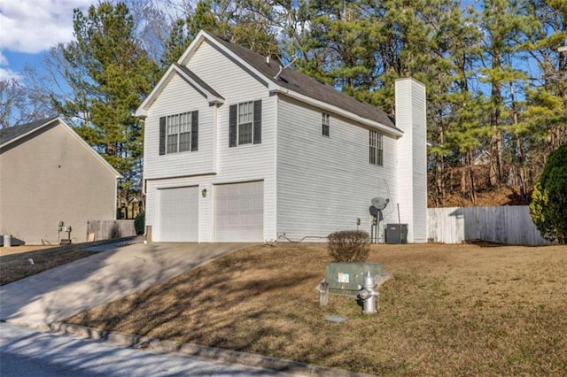 view of side of property with a garage, a yard, and central AC unit