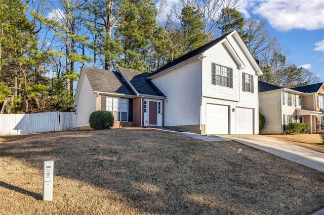 view of property featuring a garage and a front lawn