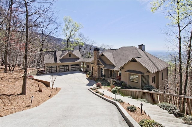 view of front of property featuring a garage and a mountain view