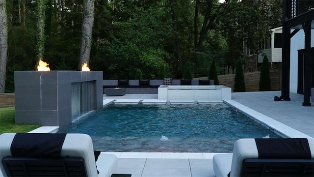 pool featuring outdoor lounge area and a patio