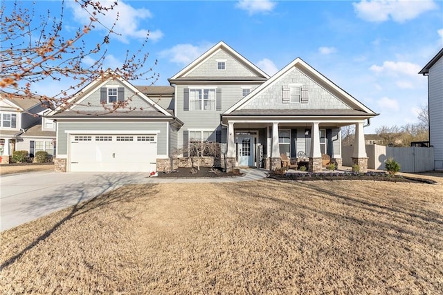 view of front of house featuring fence, a porch, concrete driveway, a front yard, and an attached garage