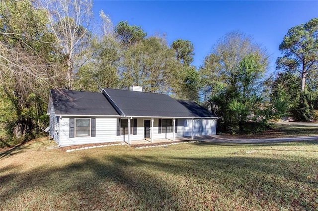 view of front of property with a front lawn, a porch, and a garage